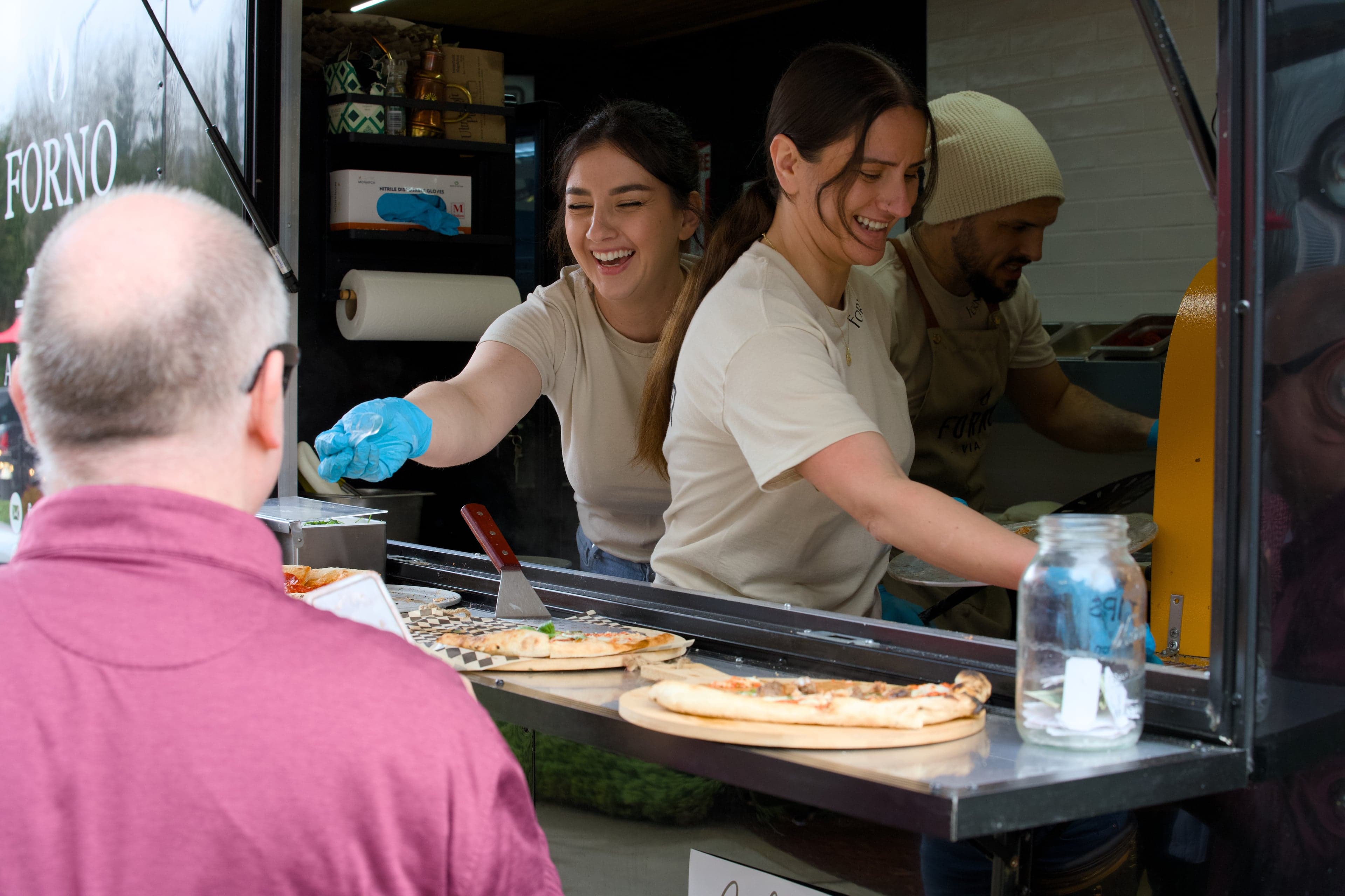 Forno Via wood-fired pizza trailer serving guests at a Seattle community pop-up event