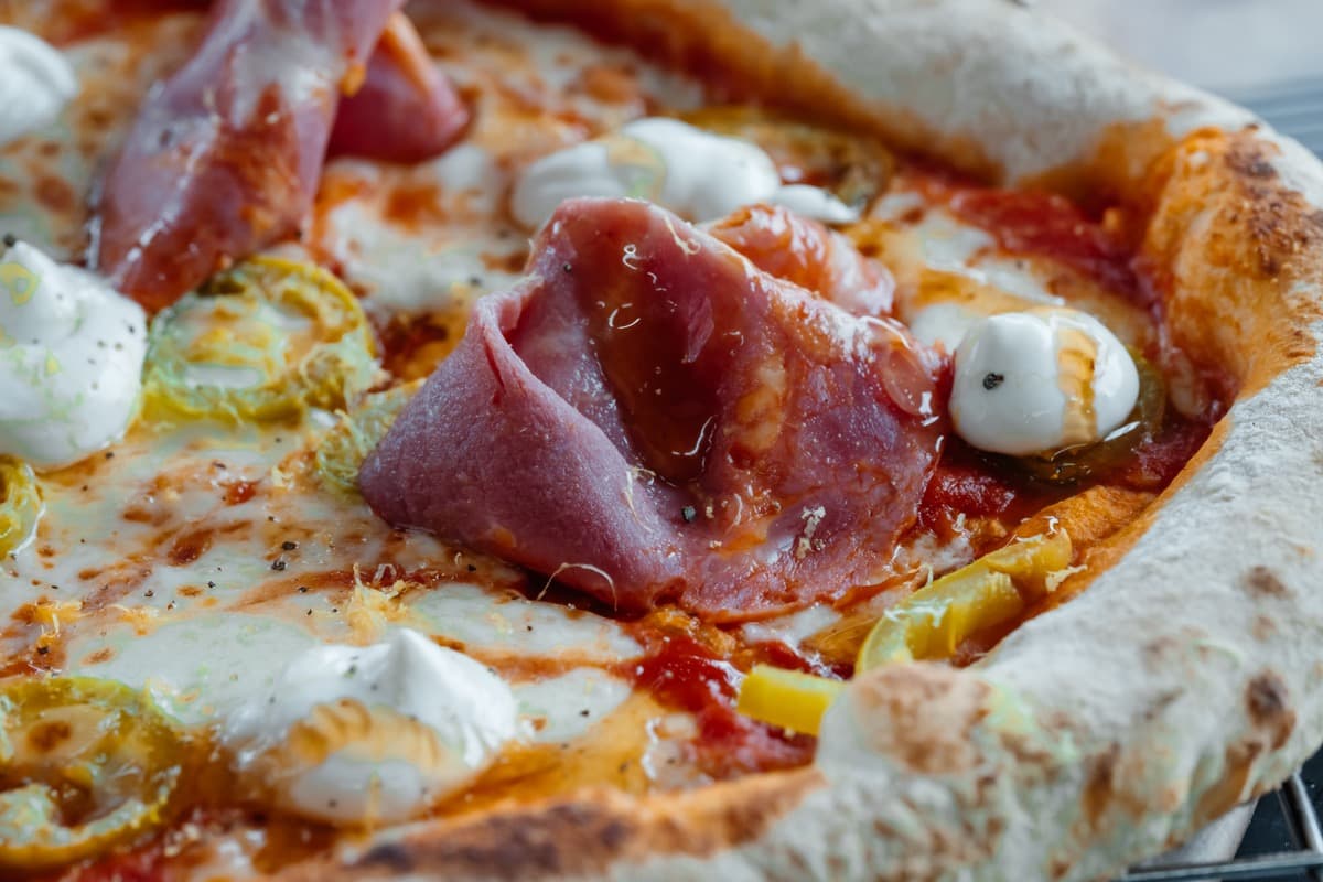 Outdoor pop-up event with Forno Via serving wood-fired pizza at a local Seattle venue