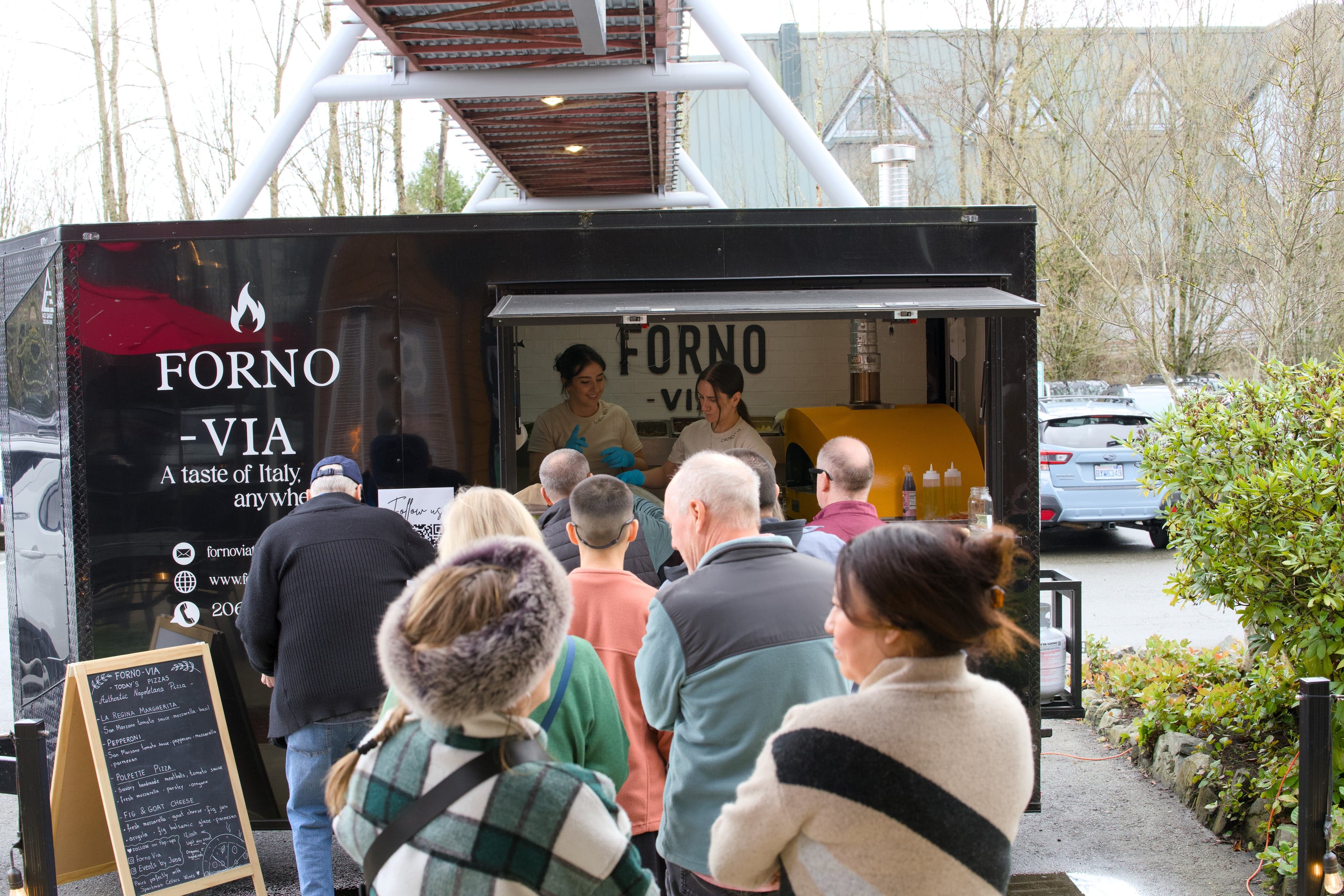 Forno Via pop-up event at a local Seattle venue with guests enjoying wood-fired pizza